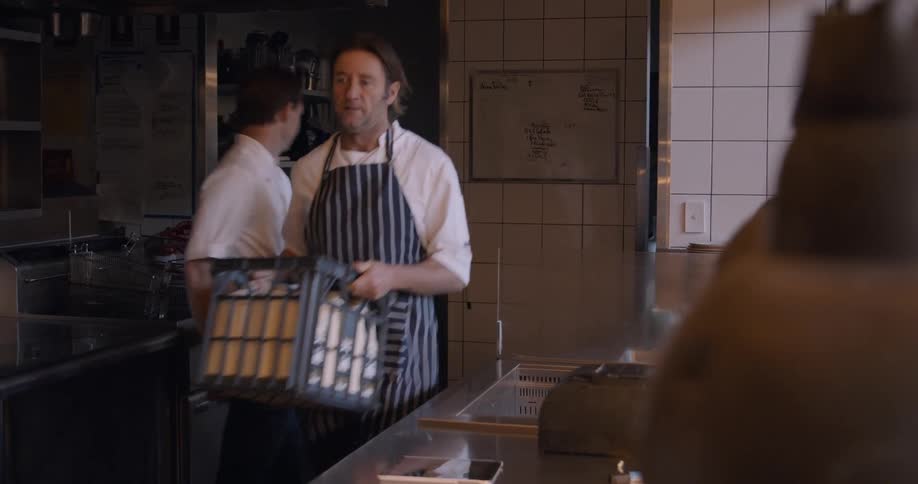 People are working in a kitchen together