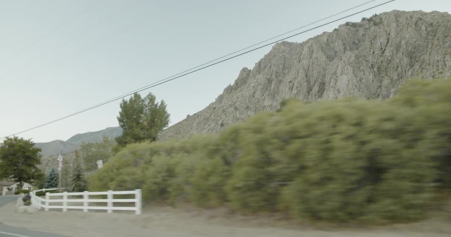 Driving past bushes and mountains