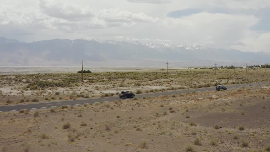 Car traveling on desolate mountain highway on cloudy day