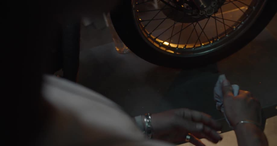 Man Working On Motorcycle In Garage