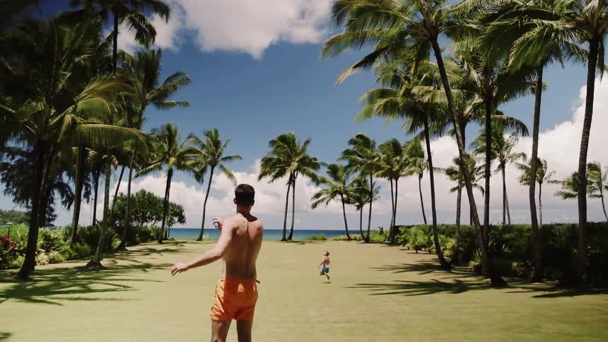 A man throws a football out to a child