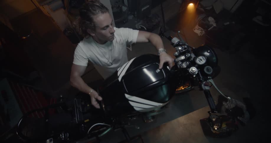 Man Working On Motorcycle In Garage