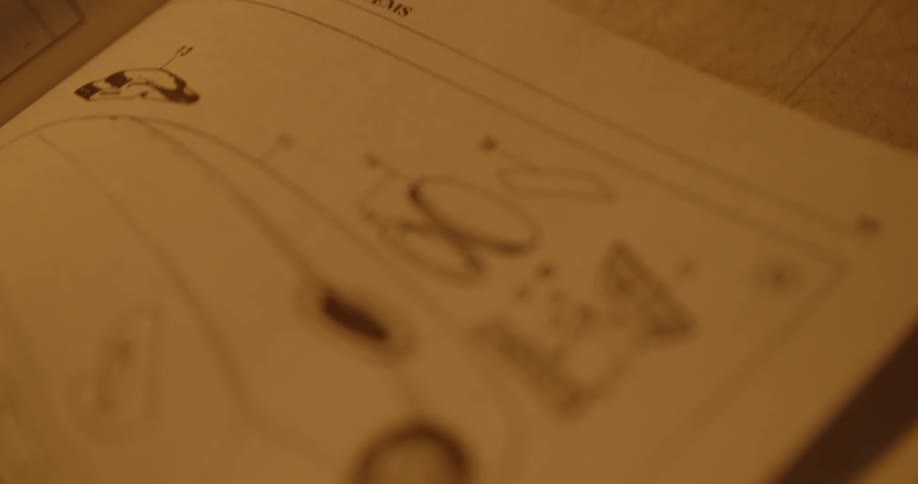 A book page with a diagram is lying open on a table