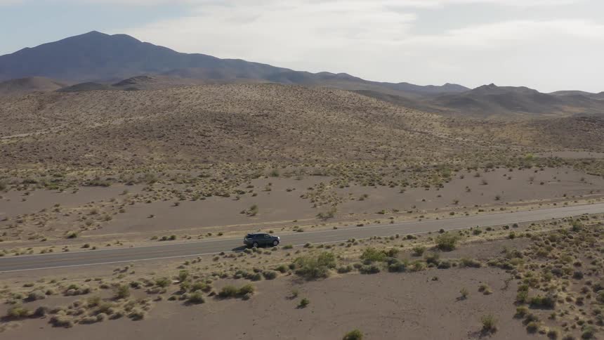 Cars travel on a desert road