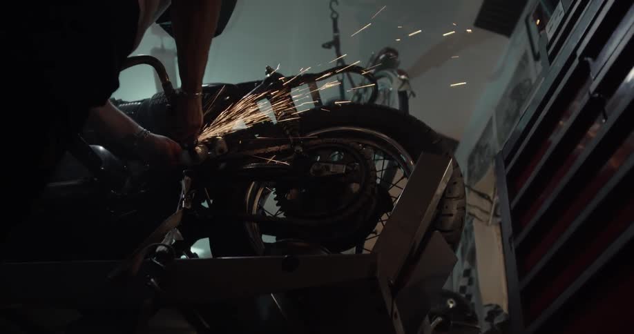 Man does some welding on a motorcycle
