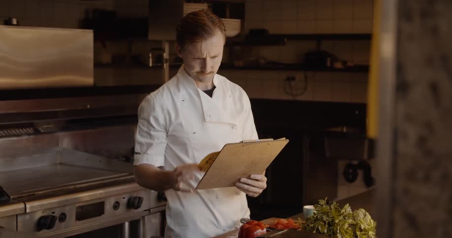 A chef works in a restaurant kitchen