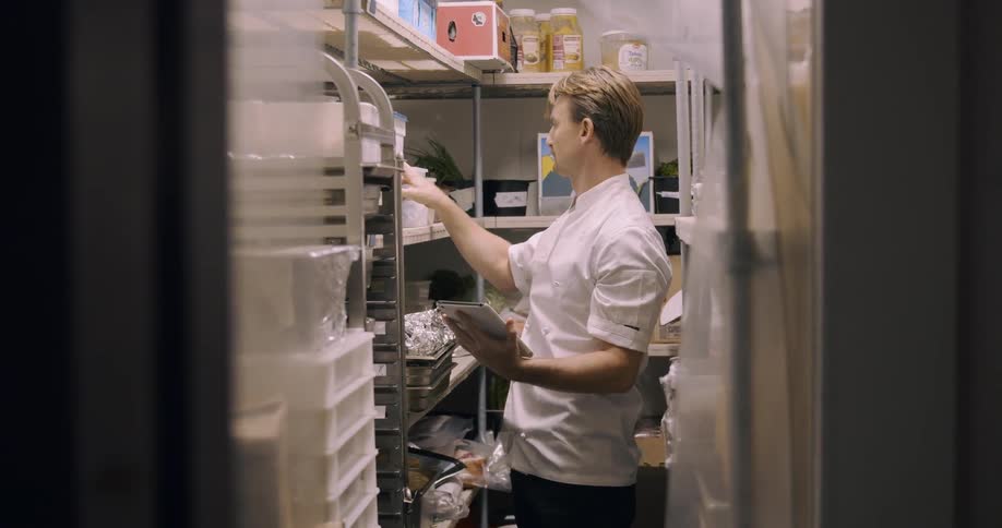 A man looks around in a stock room
