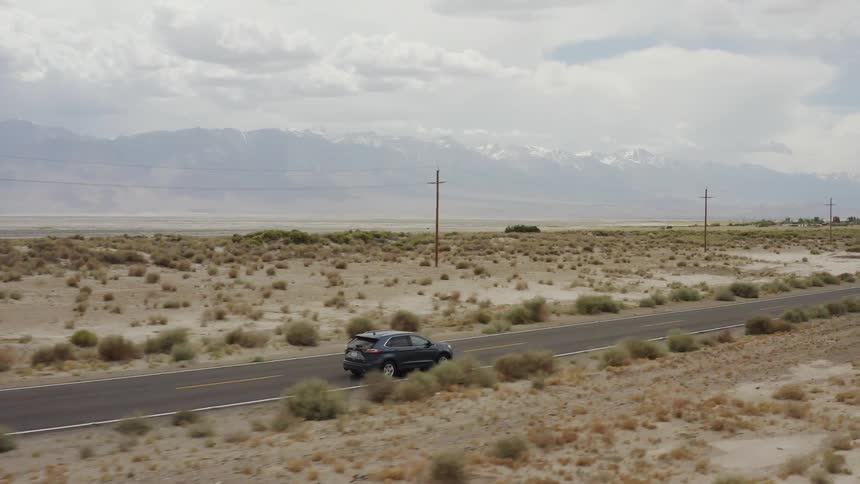 An suv travels on a desert road