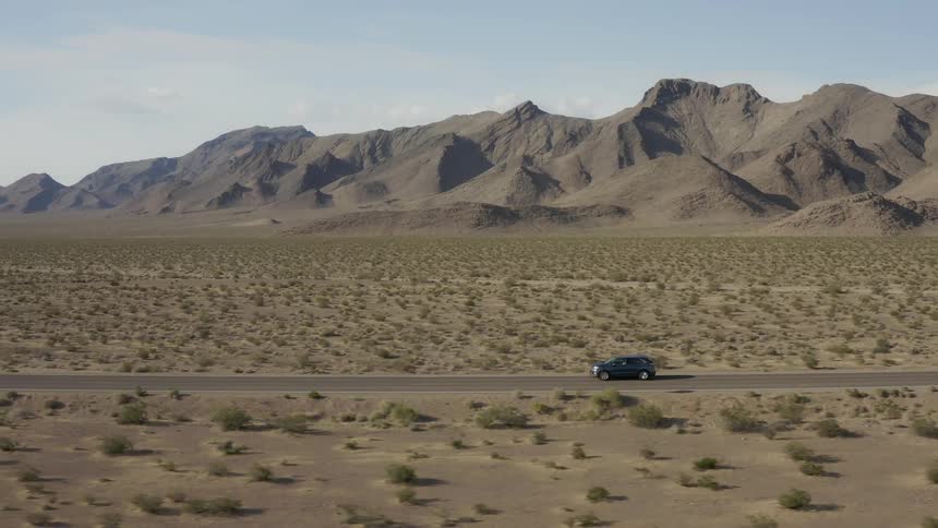 Vehicle drives in the country near mountains