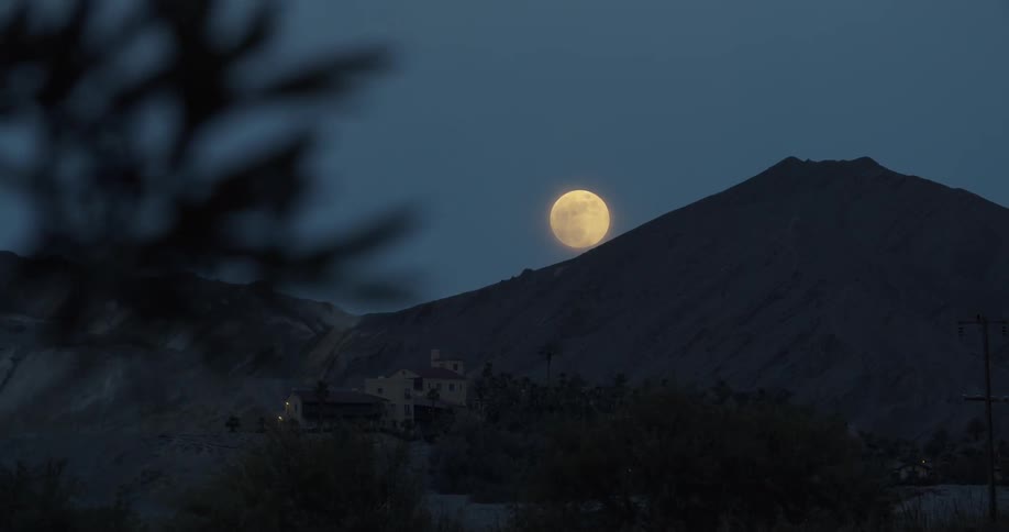 The sun is rising behind the mountain