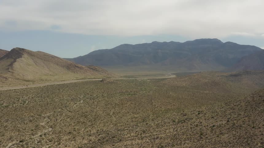 Clouds float above a mountain desert landscape