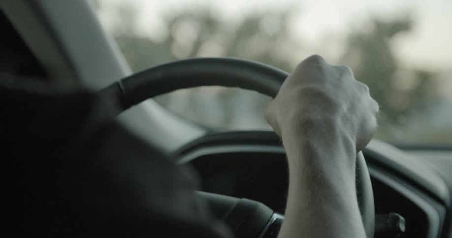 A person is driving on a cloudy day