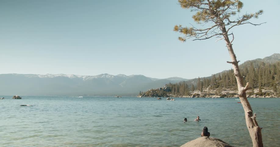 People swim in a mountain lake