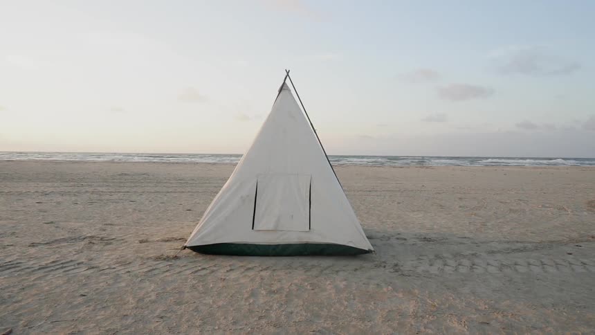 White tent on a flat sandy area