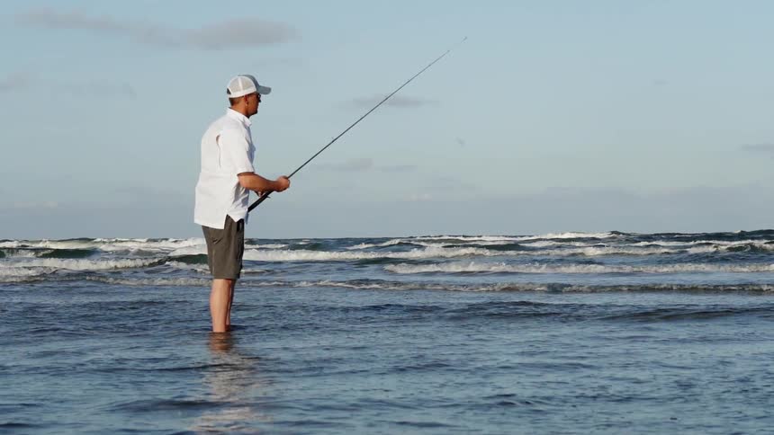 A man fishes in the ocean waters