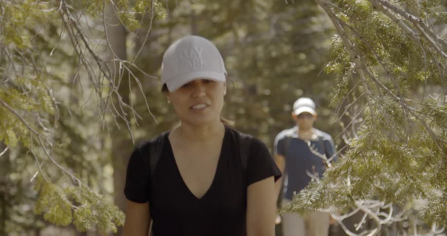 A man and woman hike together in the woods