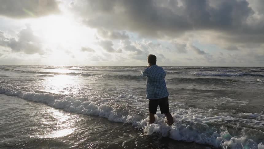 A man is fishing on the shore