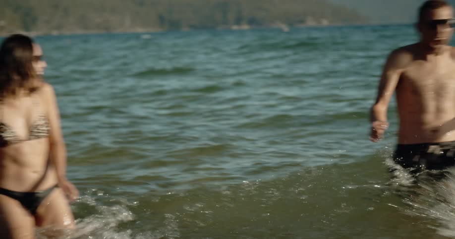 Friends splash while swimming in a lake