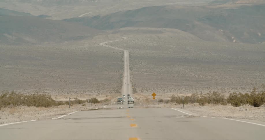Desert highway extends towards mountains