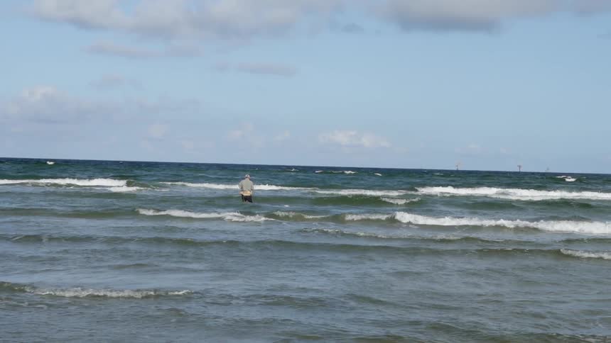 Person stands in the ocean