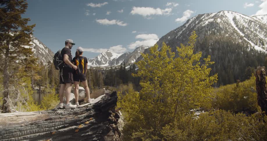 A couple kisses while hiking in mountains