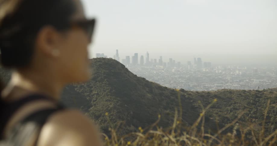 A woman looks out over the mountain range