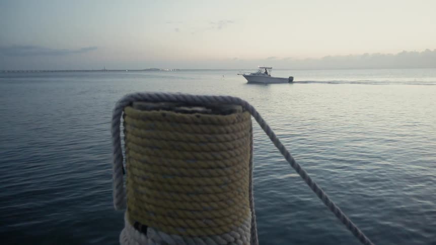The boat is slowly moving near the shore