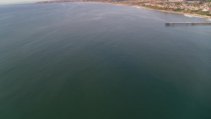 The ocean is calm near the coastal town