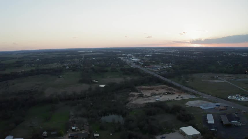 Buildings and roads in a rural landscape at sunset
