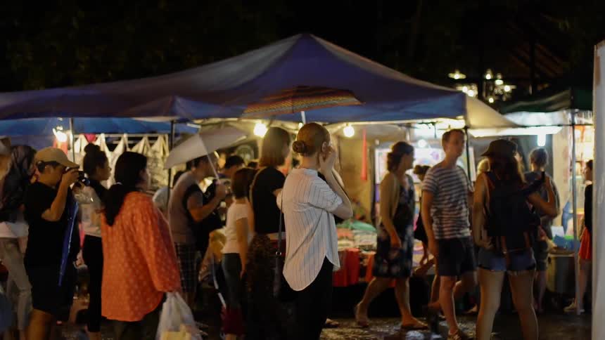 People walk at an outside market