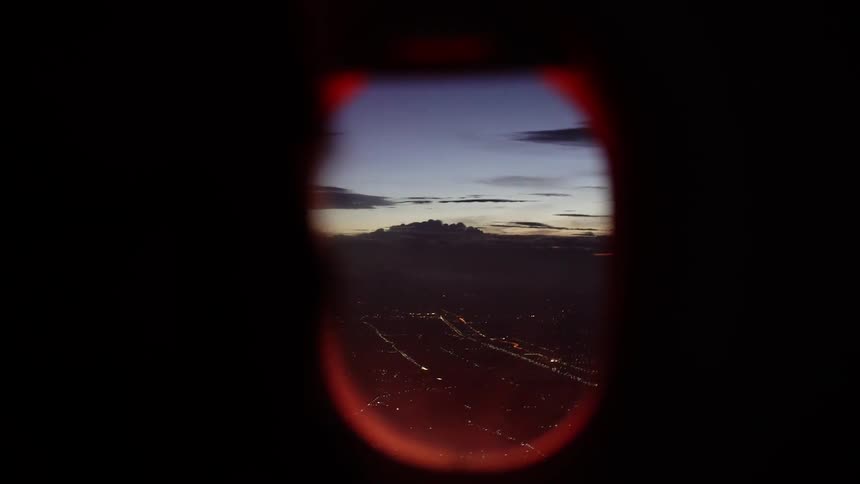 Highway lights on the ground at night from airplane window