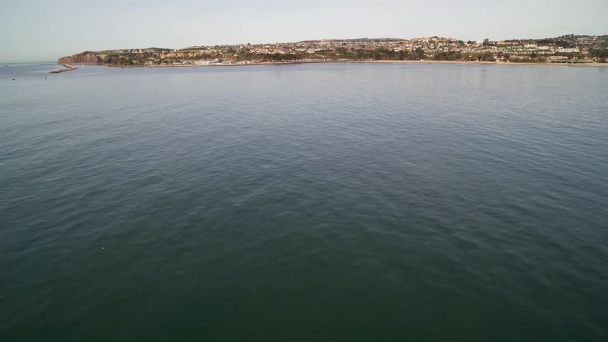 The water is calm near the town