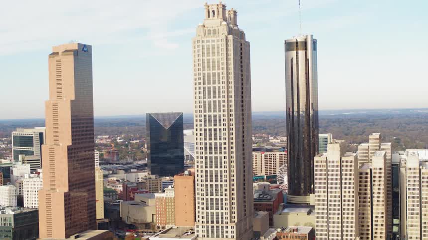 Sun shines over tall buildings in a city
