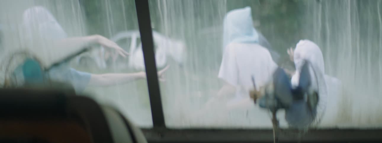 The people are dancing outside of the vehicle