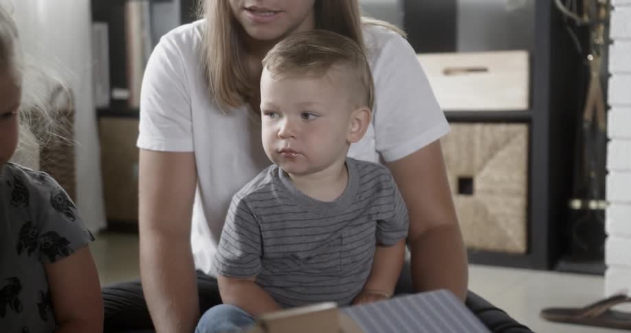 A mother reads with two of her children
