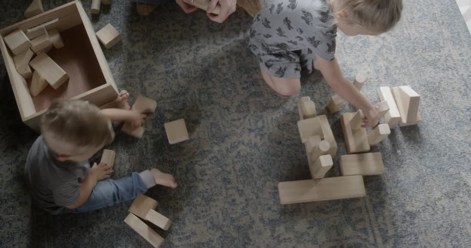The children are playing with wooden blocks