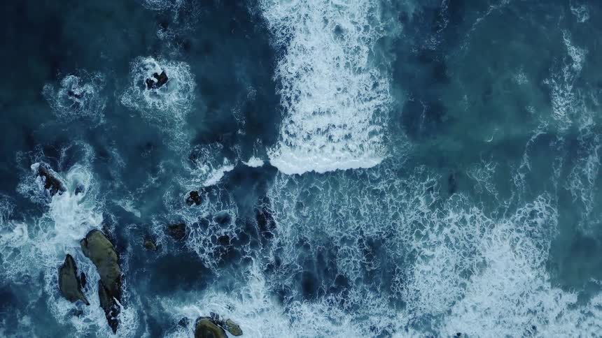 The waves slowly hit the shore below