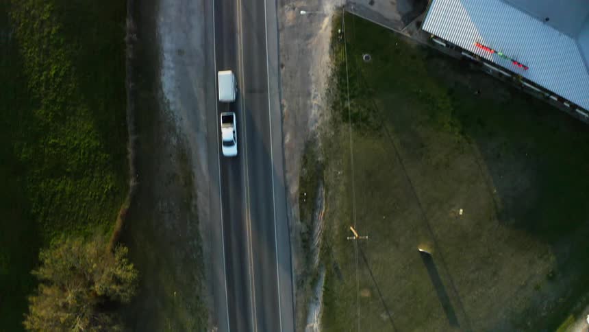 Cars travel on the road below through town
