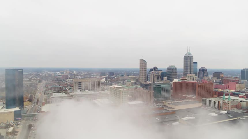 Smoke floats above a factory smokestack in a city