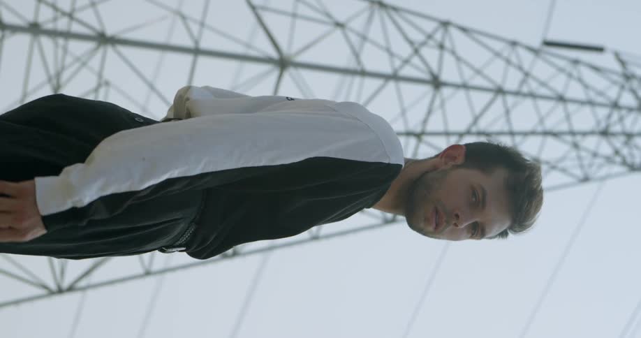 A man turns by the power lines