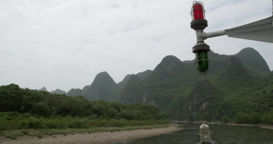 A boat is passing by the mountain