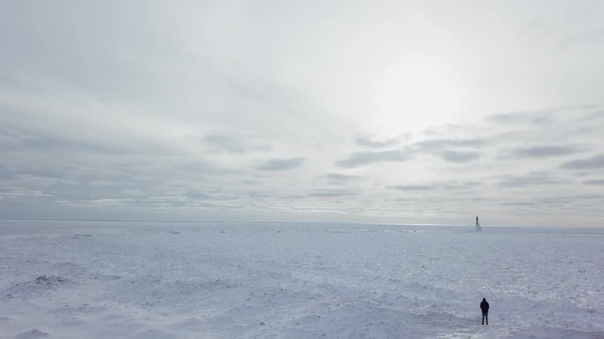 A person stands alone in a snowy expanse