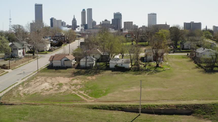 Sun shines over a neighborhood and a large city
