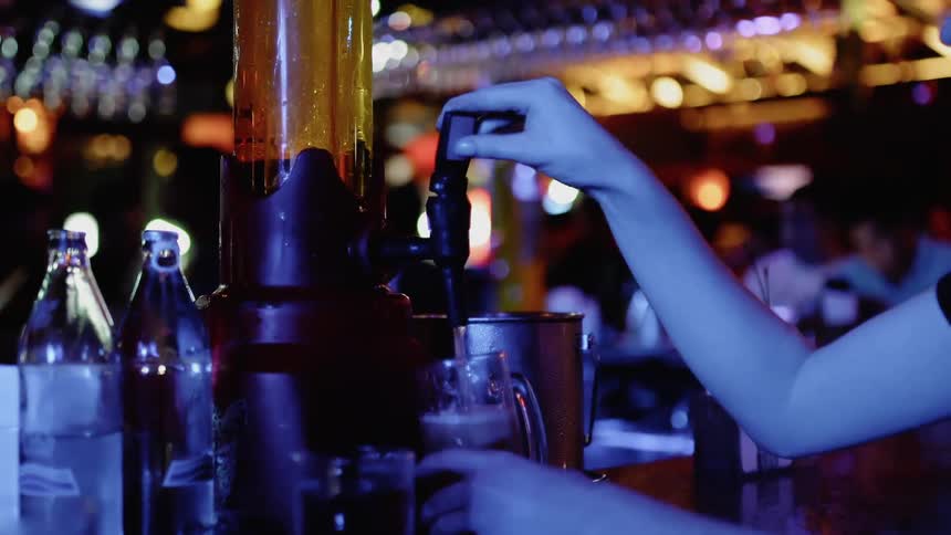 A bartender fills drinks at the bar