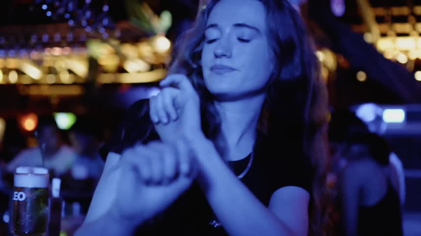 A woman dances in a bar
