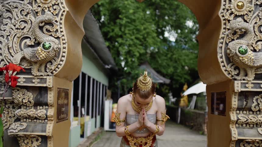 A woman bows with a costume on