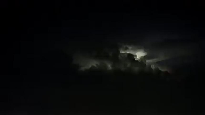 Lightning flashes in a dark night sky
