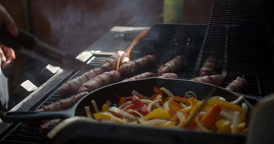 Meat and vegetables are cooked on a grill