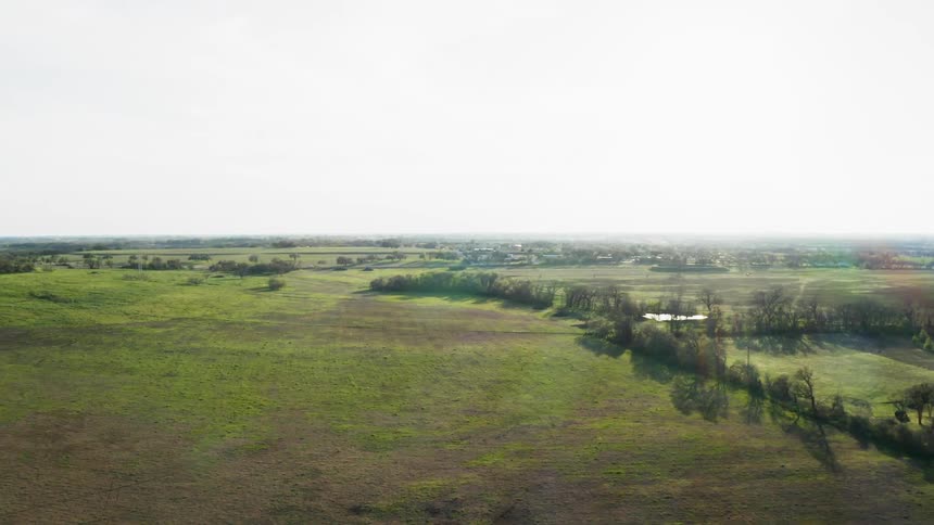 The sun shines over a rural landscape