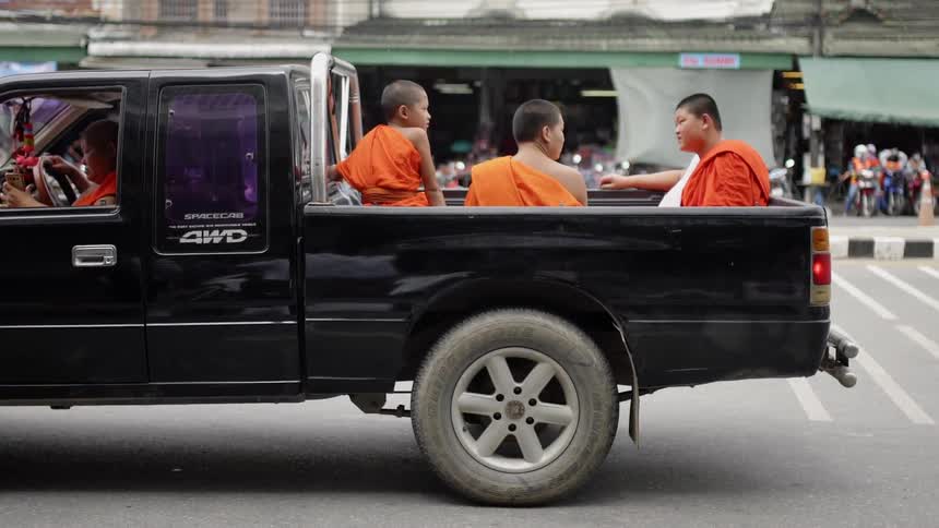 The pickup truck is holding people in the back